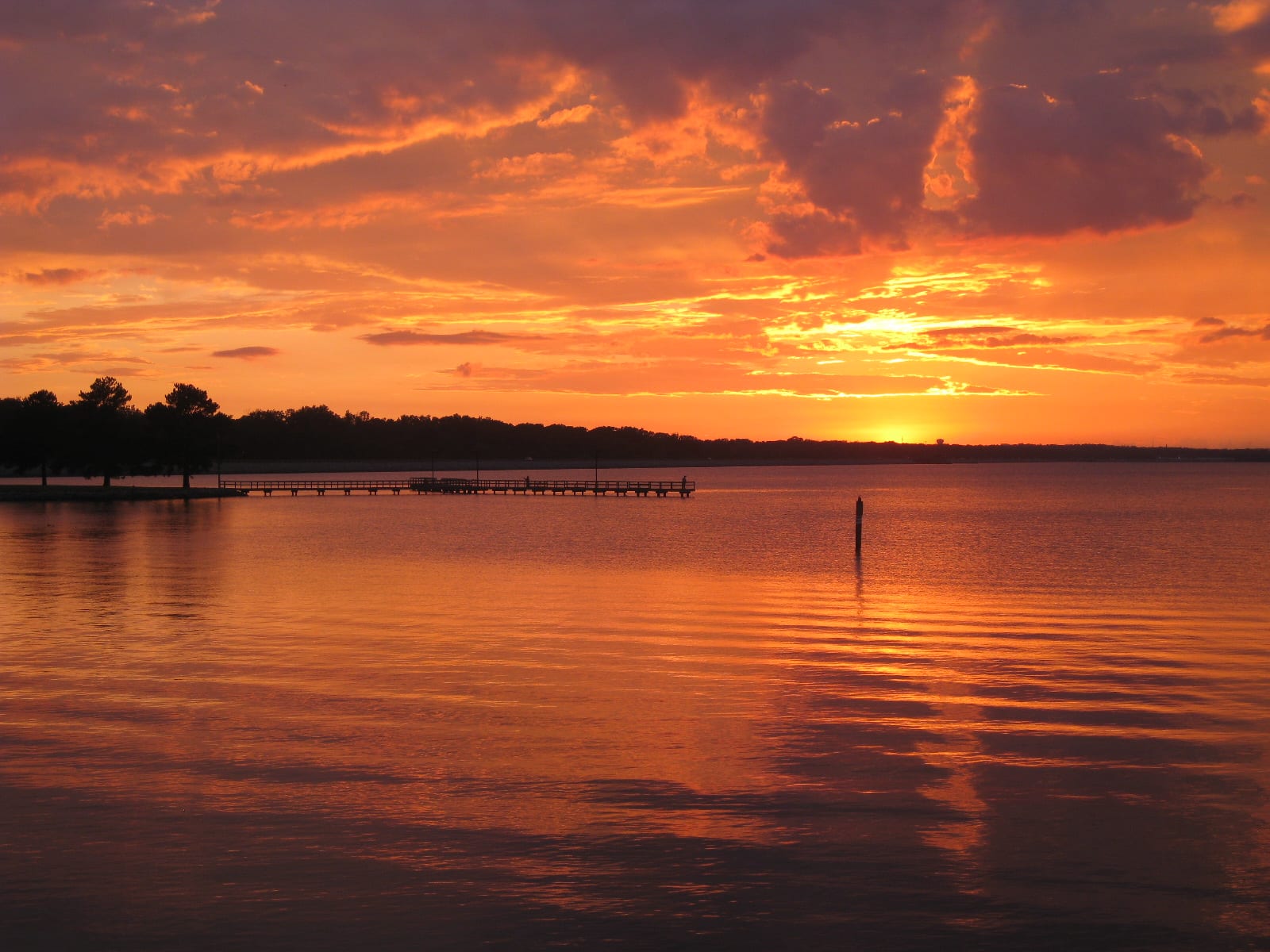 A picture of the sunsetting on the Ross Barnett Reservoir outside of my apartment in Brandon, MS. Also shows the public fishing pier near Spillway Road.