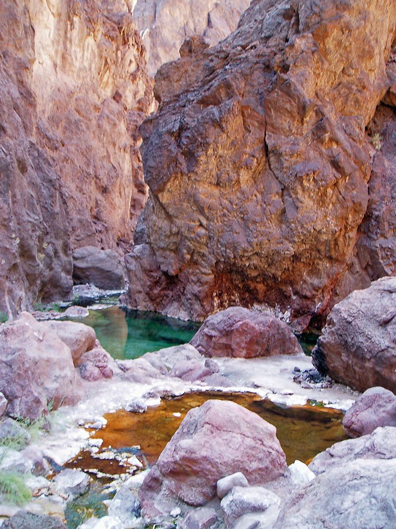Mineral-stained pools among boulders in Goldstrike Canyon, Lake Mead National Recreation Area