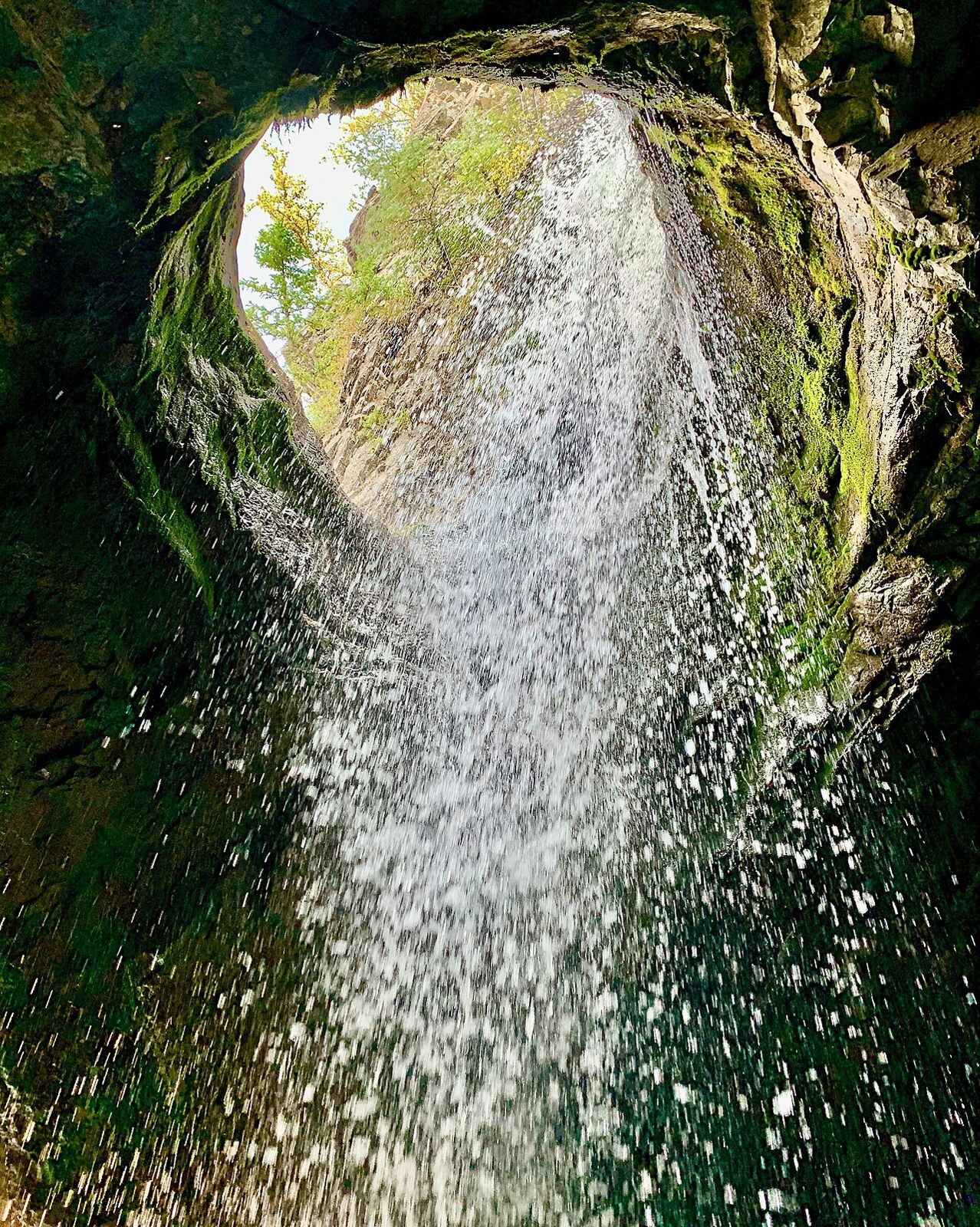 Donut Falls plunging through rock in Big Cottonwood Canyon