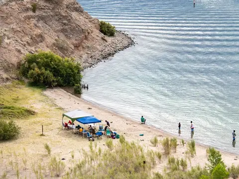 Swimmers and shade canopies at the Cottonwood Cove swim beach, seen from above