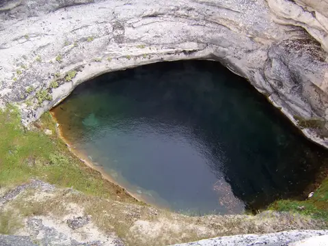 The blue-green pool at the bottom of Diana's Punch Bowl, seen from the crater rim