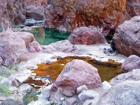 Mineral-stained pools among boulders in Goldstrike Canyon, Lake Mead National Recreation Area